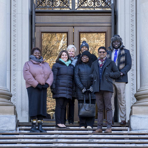 HUIT staff and Technology Enablement Initiative participants standing on library steps