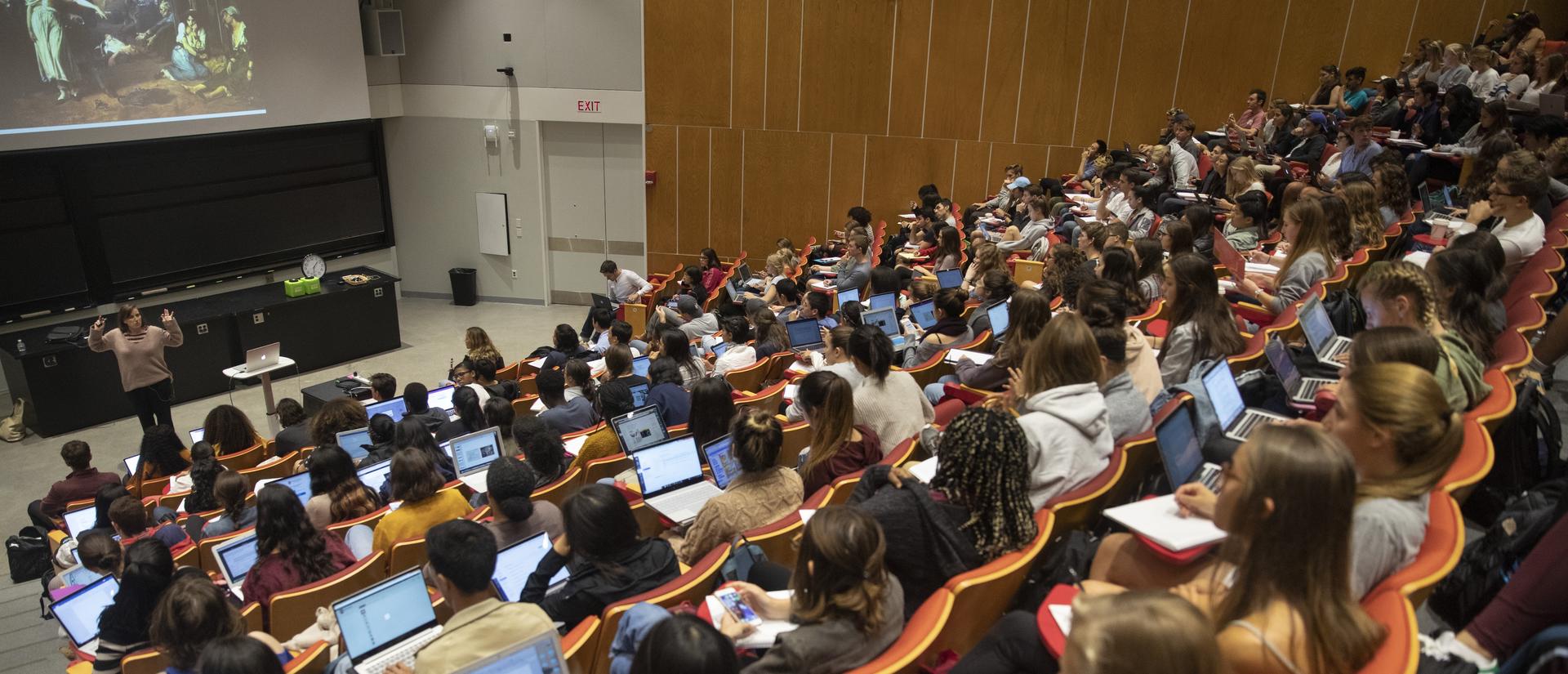 Professor gives a lecture to students on their laptops.