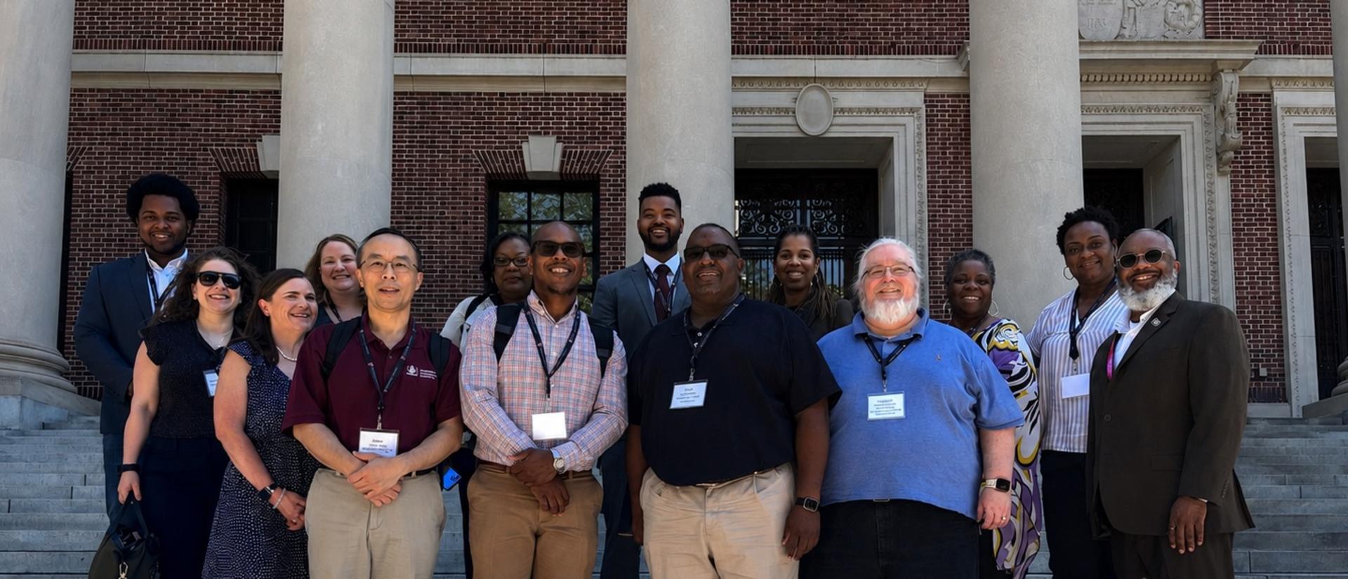 Technology Enablement Initiative cohort participants stand on Harvard library steps